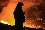 A steelworker watches as molten steel pours from one of the Blast Furnaces at a plant in Lincolnshire, UK.&nbsp;