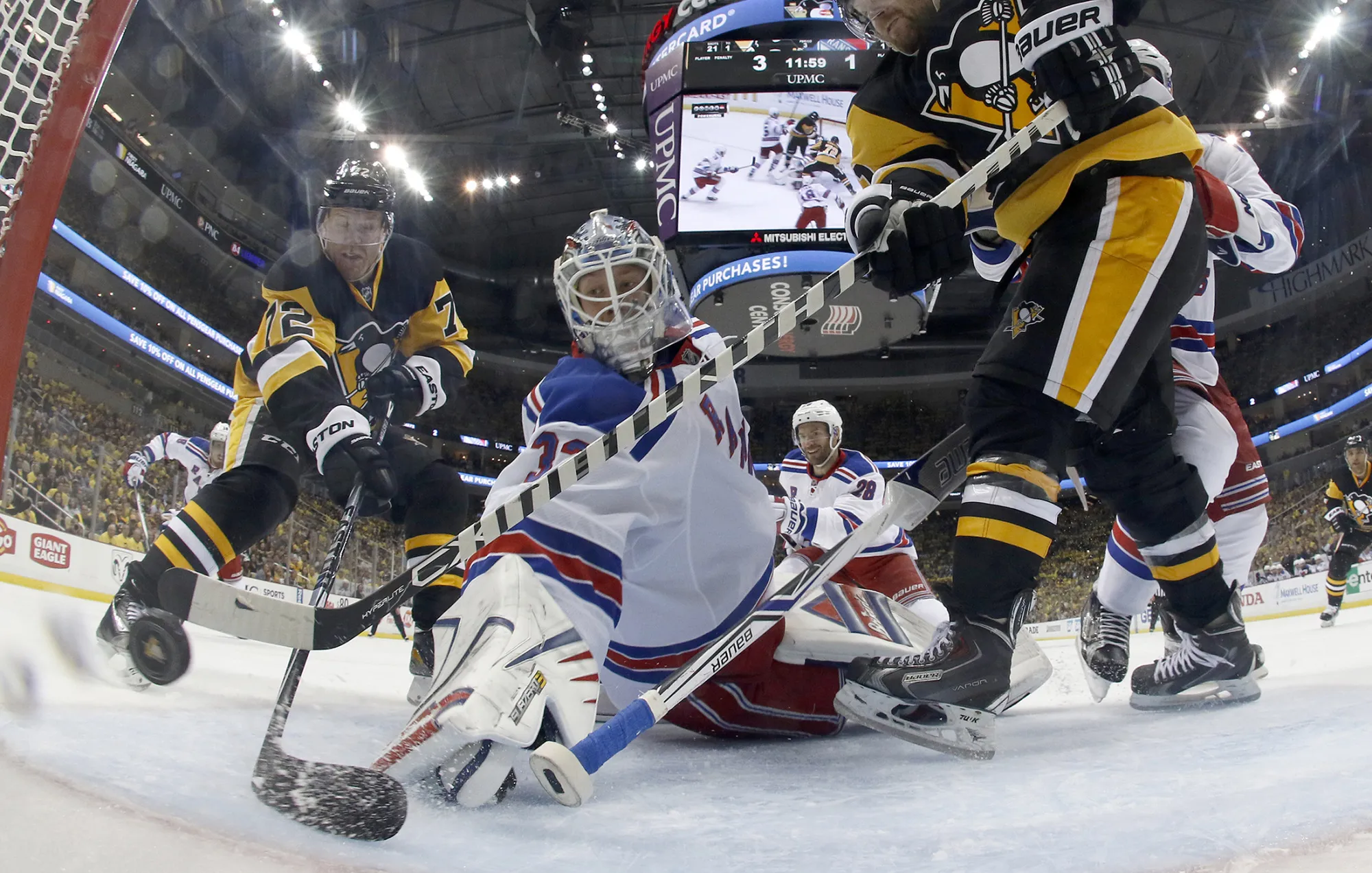 Patric Hornqvist #72 of the Pittsburgh Penguins scores past goalie Antti Raanta of the New York Rangers in Game One of the Eastern Conference Quarterfinals in Pittsburgh, Pennsylvania, on April 13, 2016.

