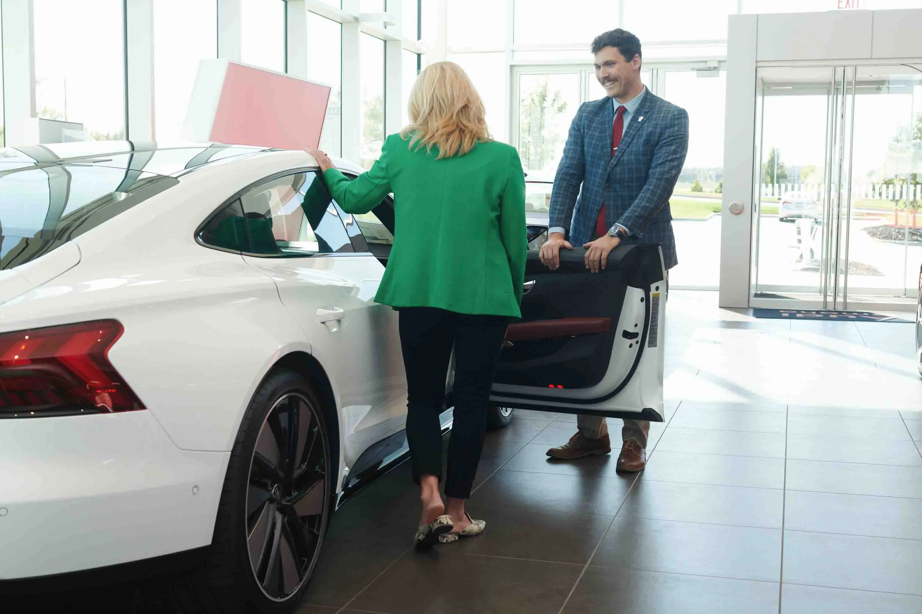 A salesperson speaks with a customer in the showroom at Audi Omaha in Omaha, Nebraska.