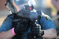 A police officer aims a tear gas launcher during a protest in St. Paul, Minnesota, on May 28.