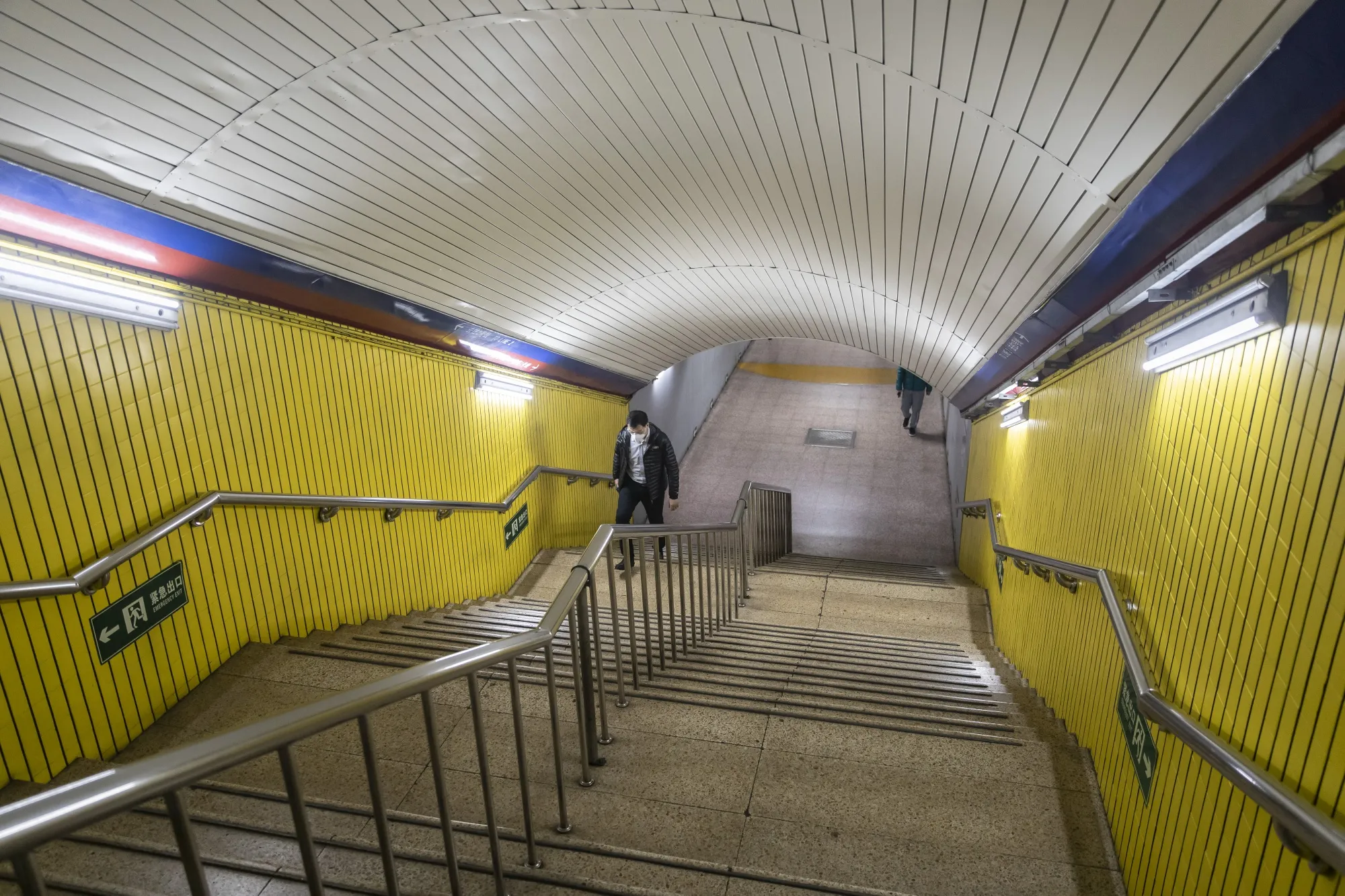 A commuter climbs a flight of steps at a subway station in Beijing on March 17.