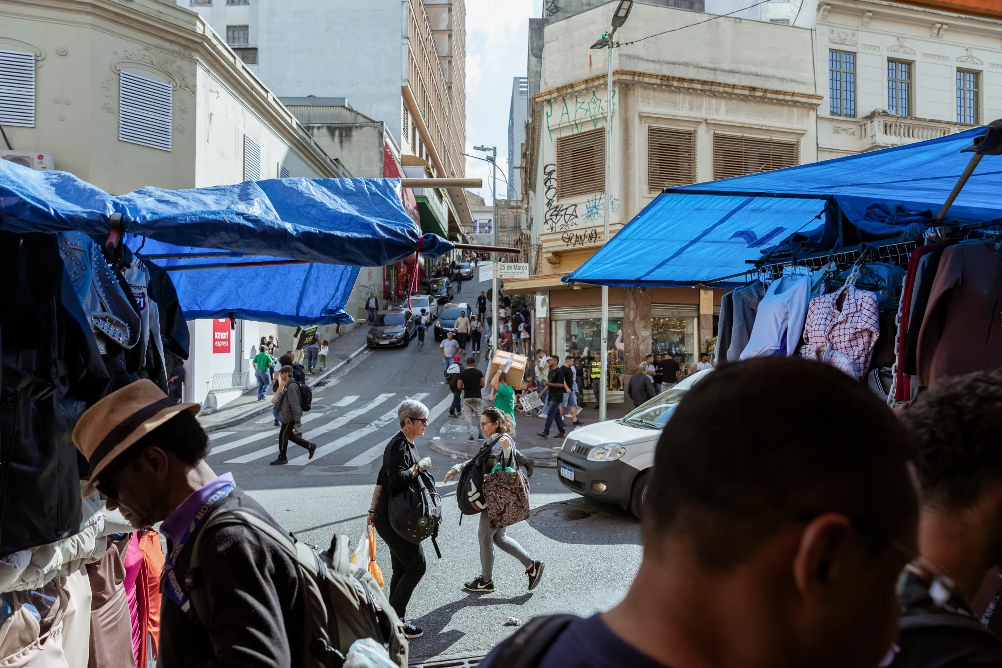 Shoppers pass retail stores in Sao Paulo.