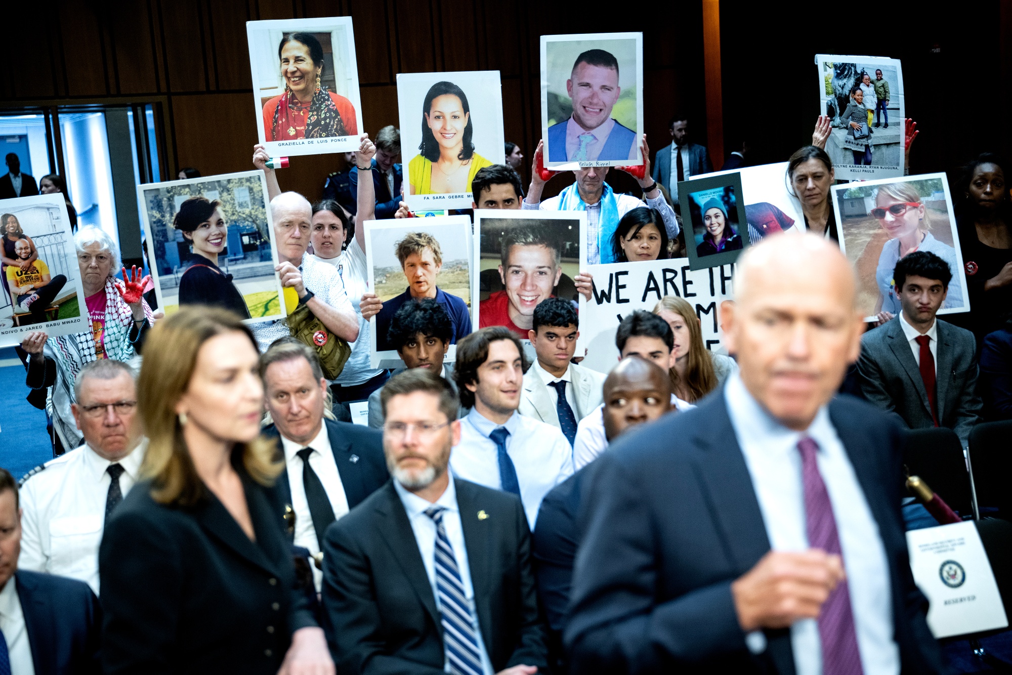 Relatives of Boeing Co. airplane crash victims hold images as Dave Calhoun, chief executive officer of Boeing Co., arrives for a Senate Homeland Security and Governmental Affairs Permanent Subcommittee on Investigations hearing in Washington, DC, US, on Tuesday, June 18, 2024.