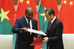 Alpha Barry, Burikina Faso’s foreign minister, and Wang Yi, China’s foreign minister, exchange documents in Beijing