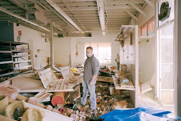 Robert Freed surveys the damage inside his Pet Foods Plus store on Nov. 18