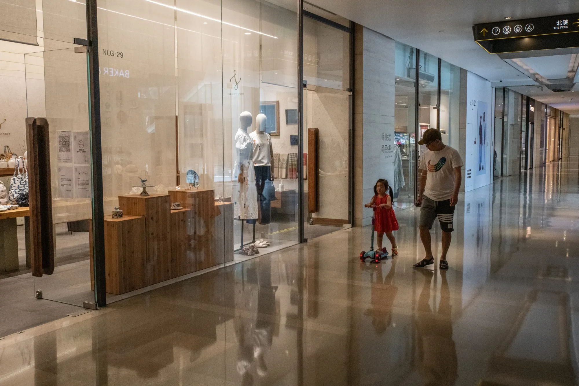 A girl rides her 3-wheel scooter inside an empty mall&nbsp;in Beijing, on June 19.