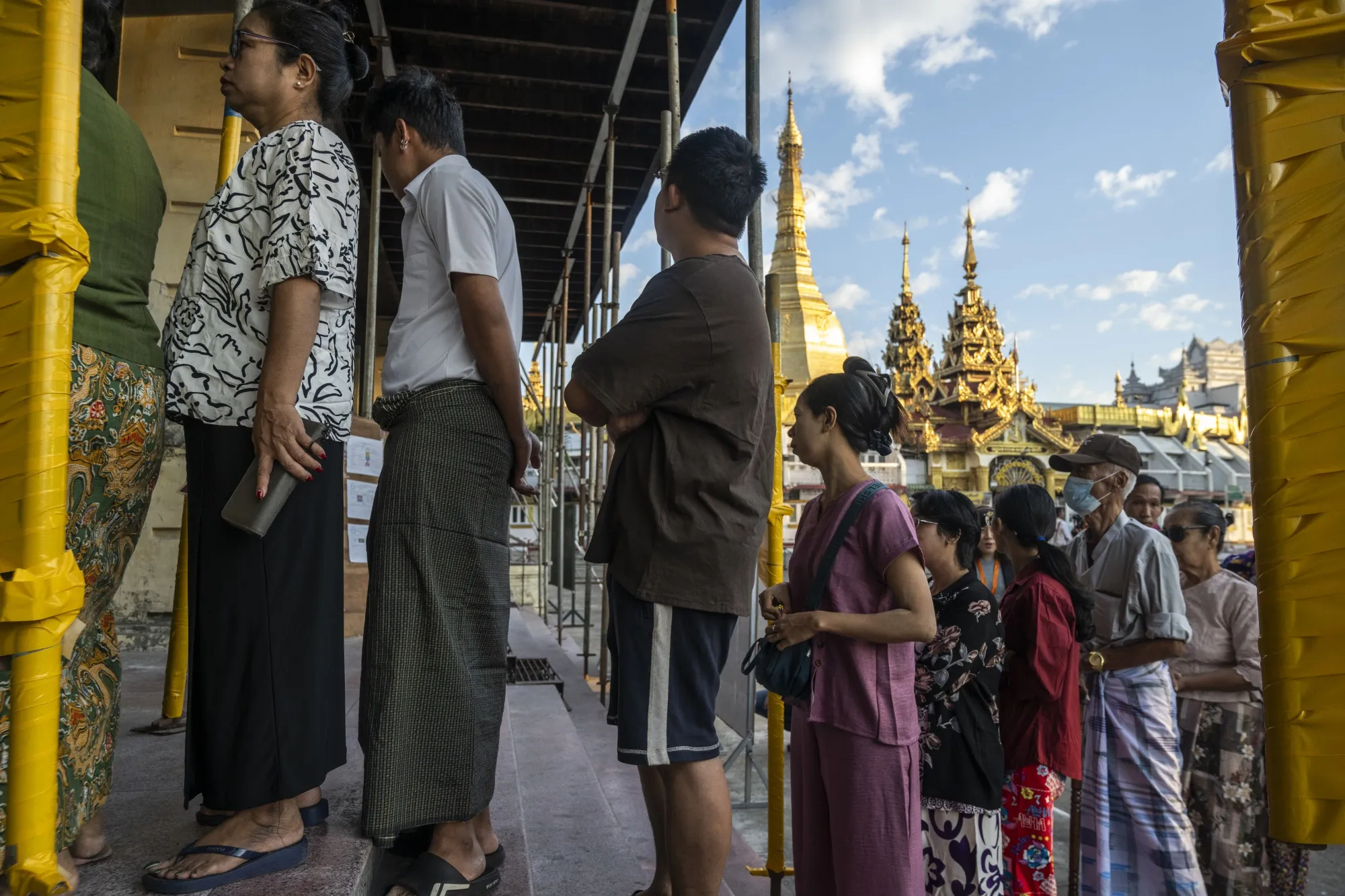 Voters line up to cast their votes at a polling station near Sule Pagoda in Yangon on Dec. 28.