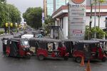 Three-wheelers line up for fuel at a gas station in Colombo on May 16.
