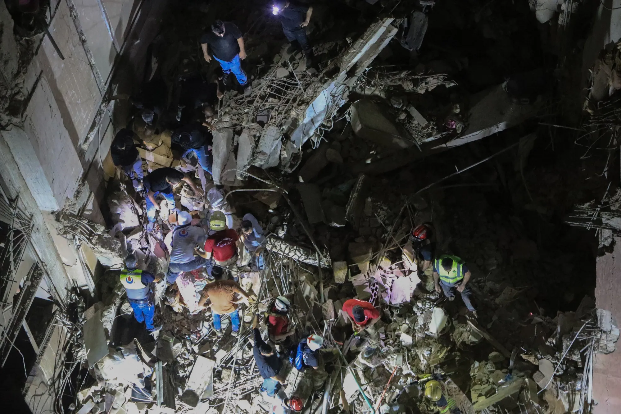 Rescuers search through the debris of a building destroyed following an Israeli military strike in Beirut on July 30.