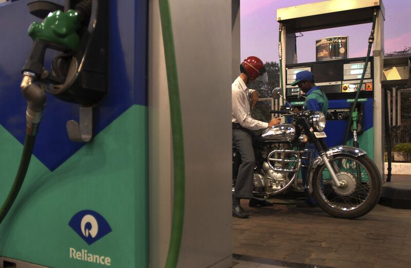 An customer at a Reliance gas station fills the tank of his