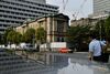 Pedestrians walk past the Bank of Japan (BOJ) headquarters in Tokyo, Japan, on Wednesday, Sept. 13, 2017. The BOJ's next monetary policy meeting is scheduled for Sept. 21. The central bank pushed back in July the projected timing for reaching its 2 percent inflation target for the sixth time as economic growth failed to drive price gains.