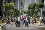 Pedestrians in the central business district in Singapore, on Tuesday, April 26, 2022. 