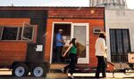 Kayla Byers and Jan Nordlund leave after a tour from Cameron Scott of his tiny house in front of the Capitol building in Salem, Ore., May 24, 2018. Scott, who owns a company that builds the units, parked his tiny house in front of the Capitol as part of a push by manufacturers of the micro-dwellings to get lawmakers to reverse a recent rule change.