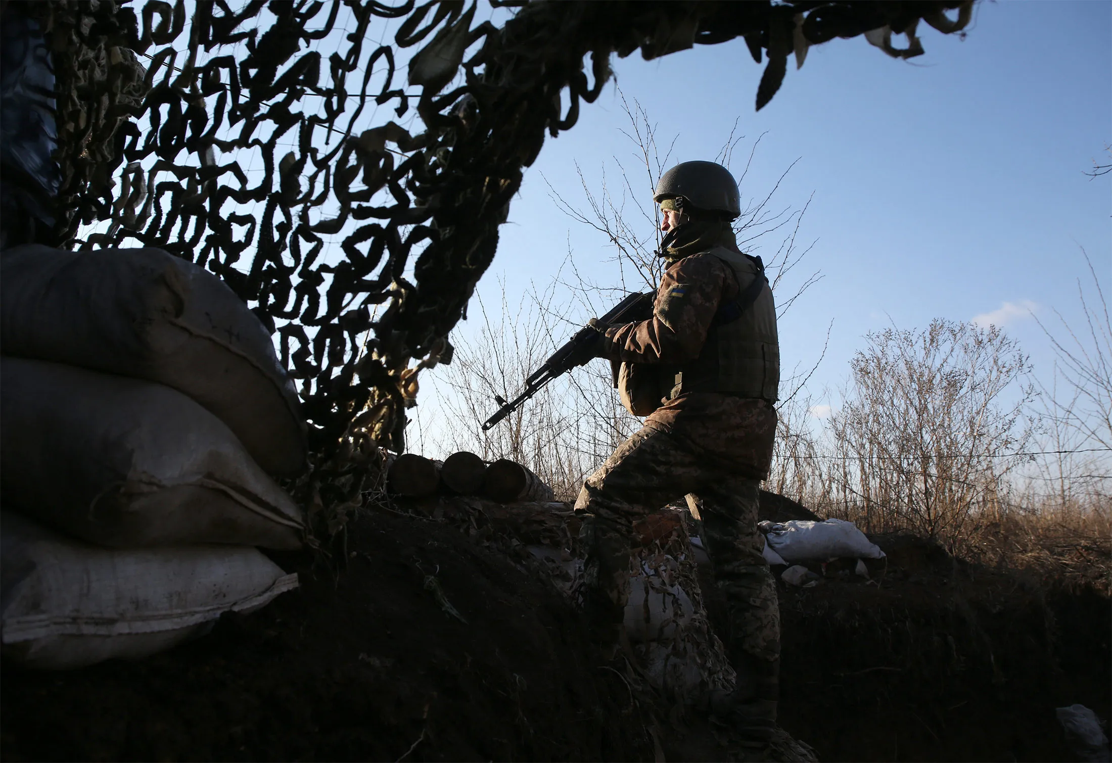 A Ukrainian serviceman keeps watch at a position on the frontline with Russia-backed separatists not far from Gorlivka, Donetsk region, on Nov. 25.&nbsp;
