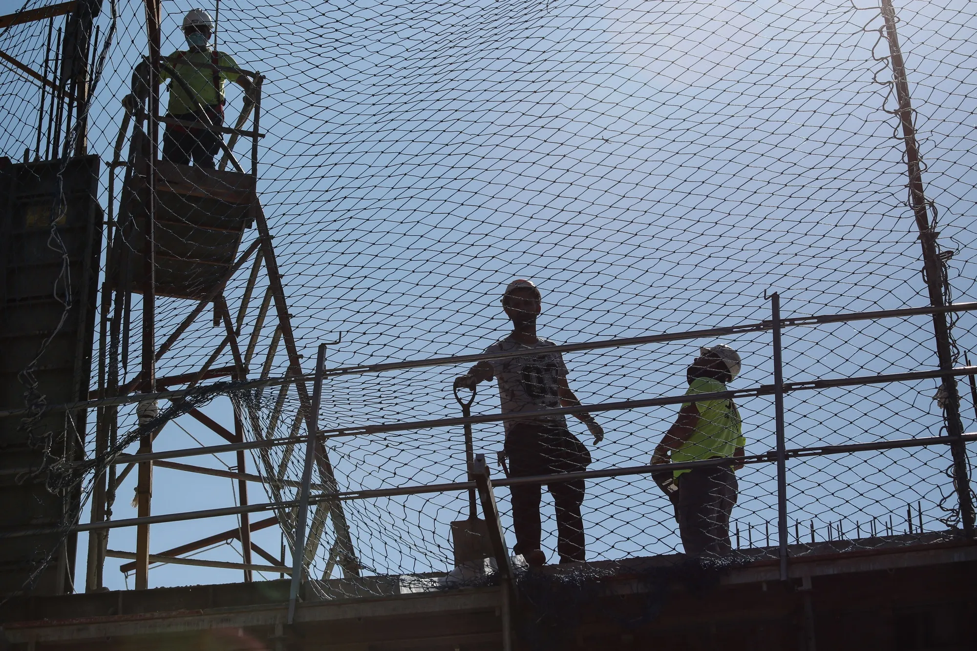 Laborers work at a construction site in Barcelona, on April 14.