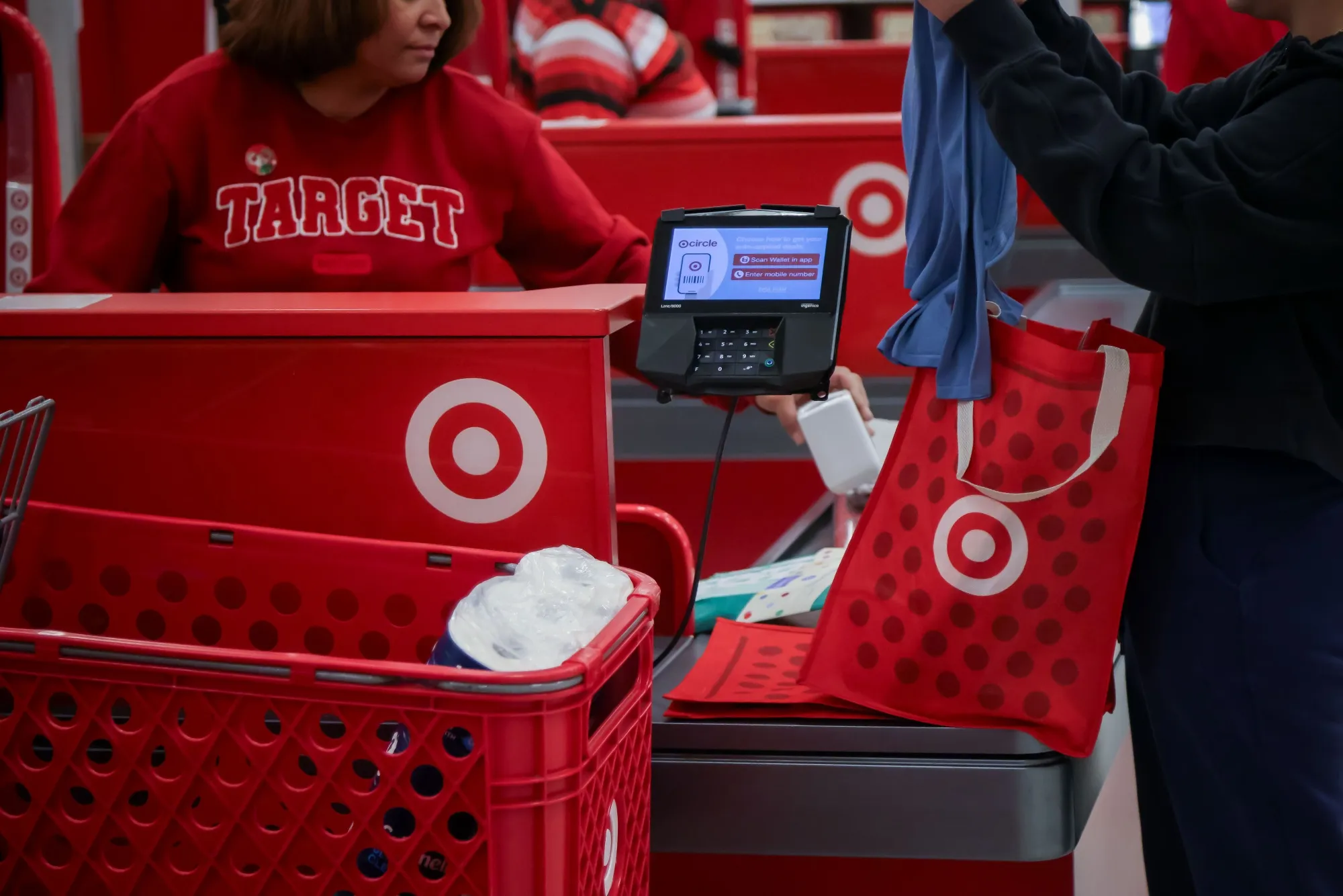 Workers check customers out at a Target store Jersey City, New Jersey.