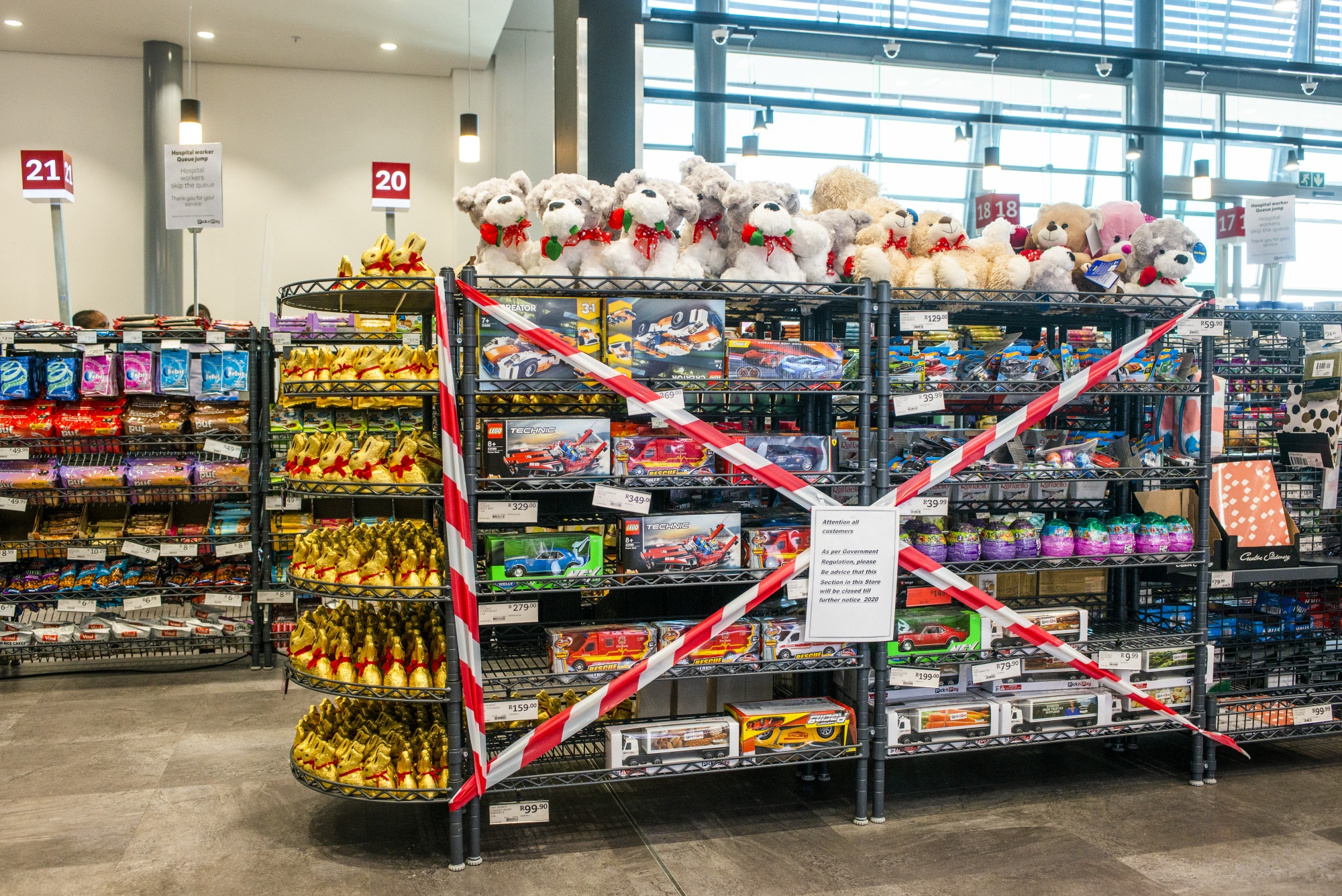 Barrier tape cordons off children's toys, banned for sale under government lockdown regulations, inside a supermarket in Johannesburg, on May 11.