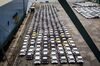 Newly manufactured imported automobiles sit on the dockside in the Auto Terminal SA parking lot at the port of Barcelona.