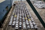 Newly manufactured imported automobiles sit on the dockside in the Auto Terminal SA parking lot at the port of Barcelona.