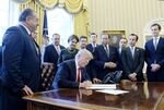 President Donald Trump signs an executive order at the White House in 2017.