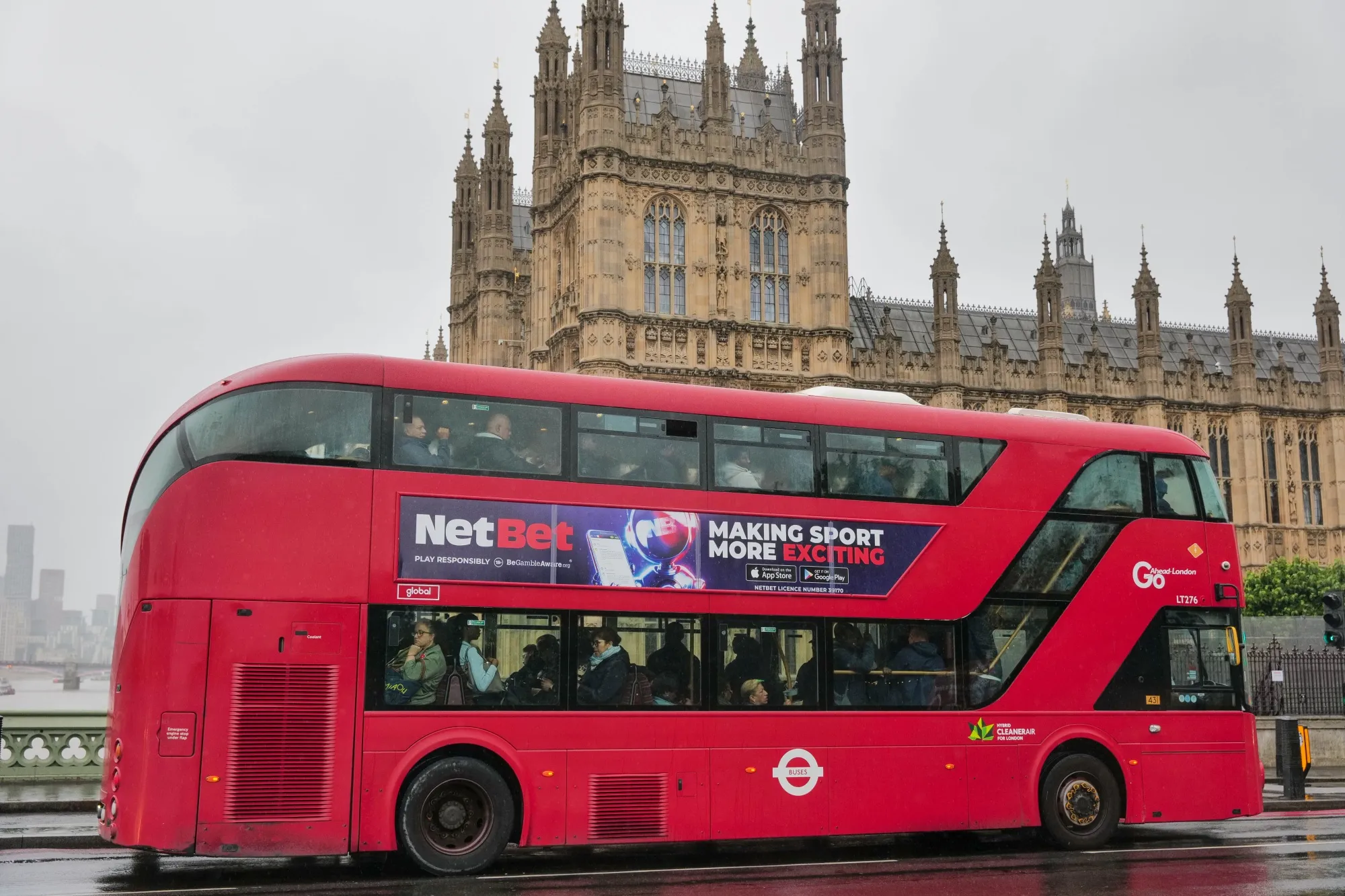 Commuters on a bus pass the Houses of Parliament in London.