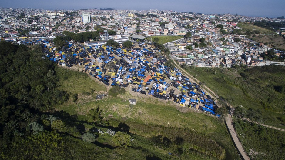 Shacks with tarp roofs dot the hillside of MTST’s Paulo Freire Occupation on the outskirts of São Paulo.