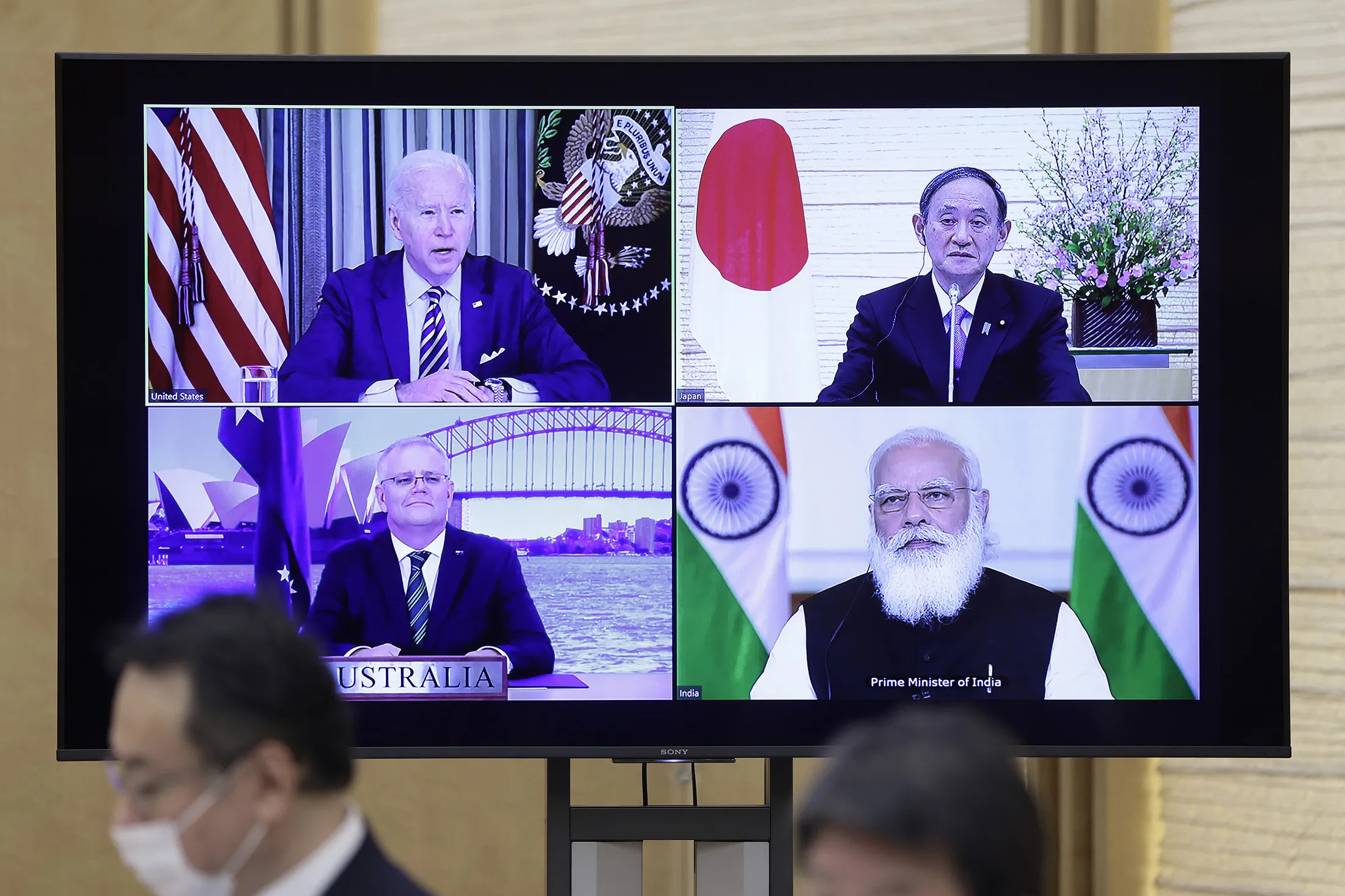 (Clockwise from top left) U.S. President Joe Biden, Japanese Prime Minister Yoshihide Suga, Indian Prime Minister Narendra Modi, and Australian Prime Minister Scott Morrison on a monitor during the virtual Quadrilateral Security Dialogue (Quad) meeting at Suga’s official residence in Tokyo on March 12.
