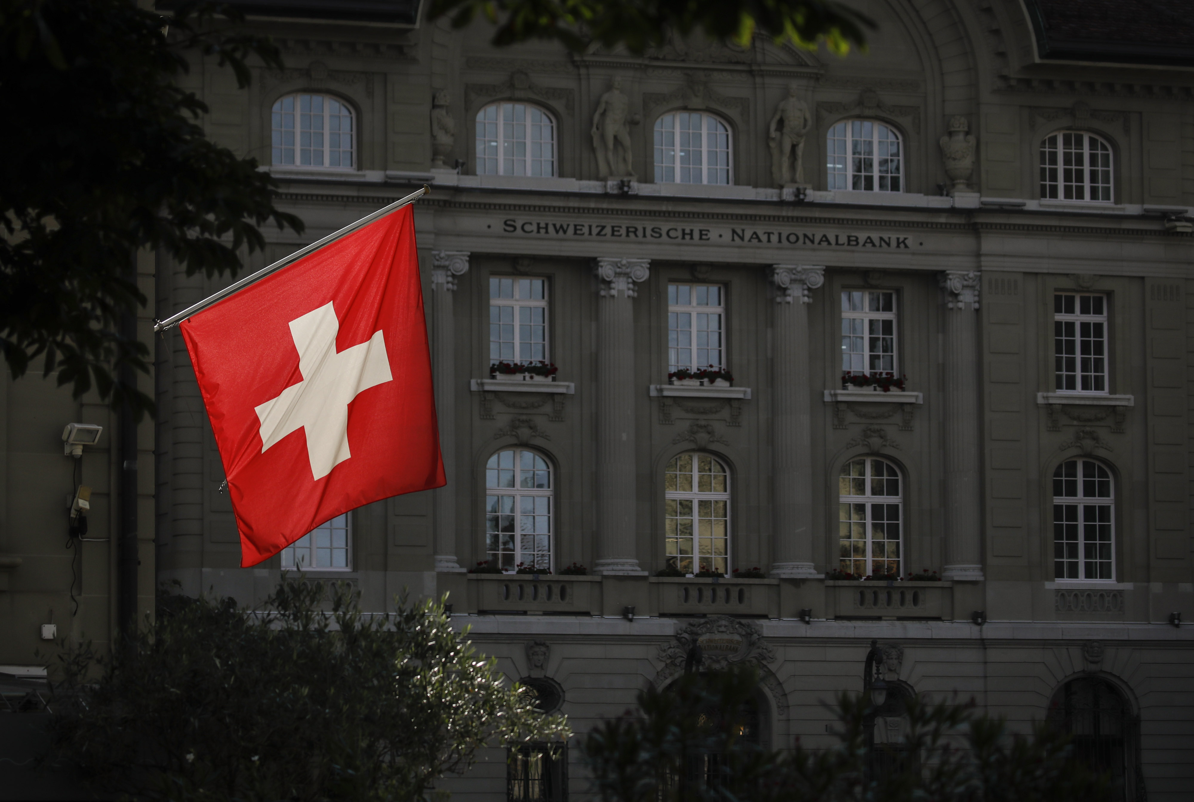 A Swiss national flag flies in front of the Swiss National Bank&nbsp;in Bern.