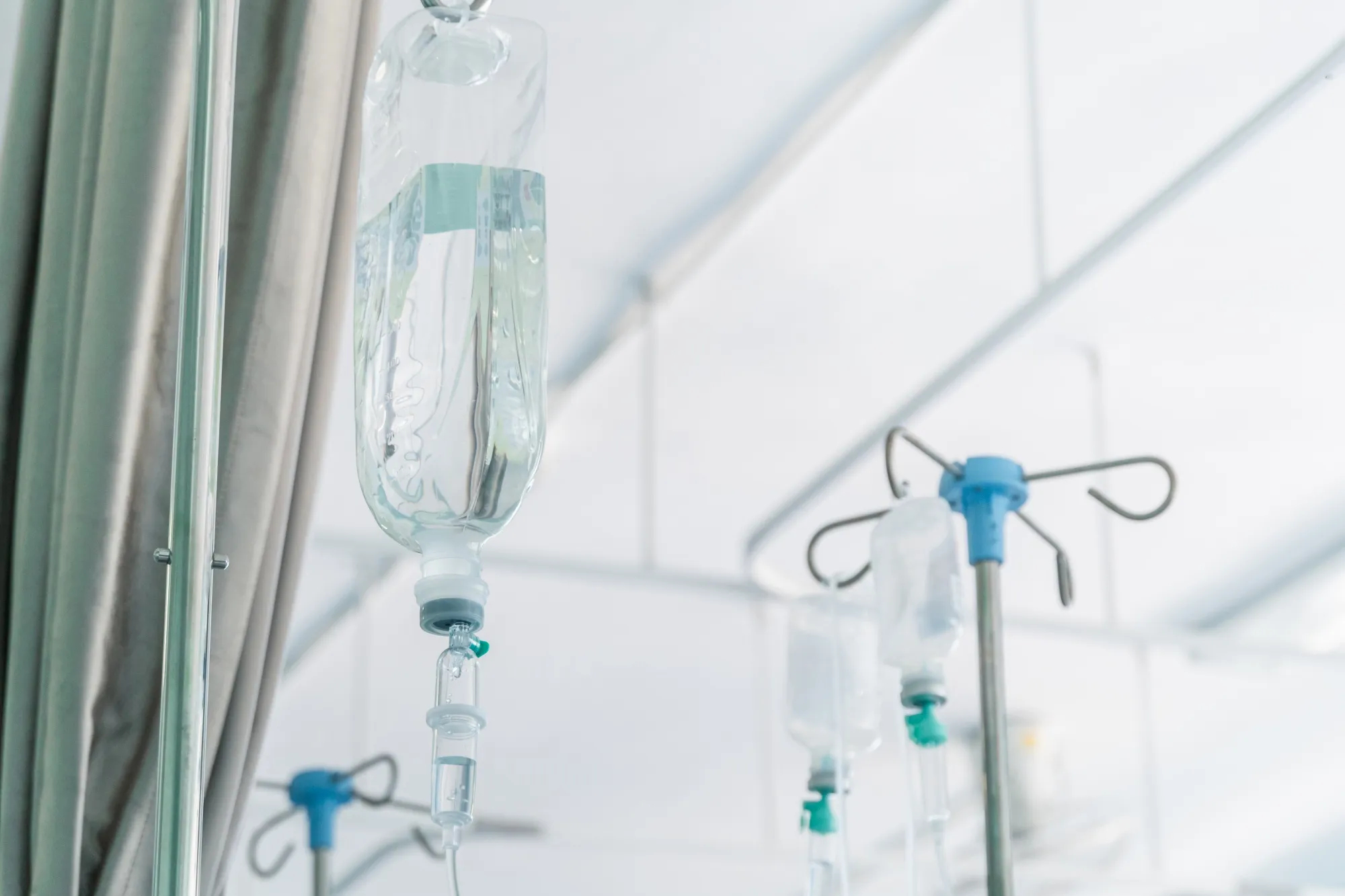 Saline Drip Hanging On Metal Hook Against Wall In Hospital rf IV hospital