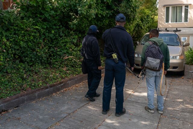 Berkeley Fire Department members speak with a resident during an inspection.