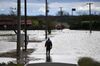 A member of Japan's Fire and Disaster Management Agency wades through floodwaters in the aftermath of Typhoon Hagibis in Kurihara city, Miyagi Prefecture.