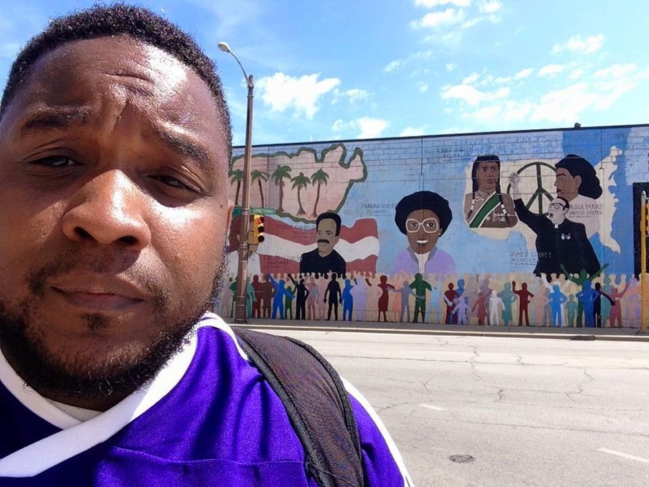 Activist Tory Lowe stands before a mural in Milwaukee, Wisconsin.