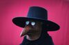 A man dresses as a plague doctor.