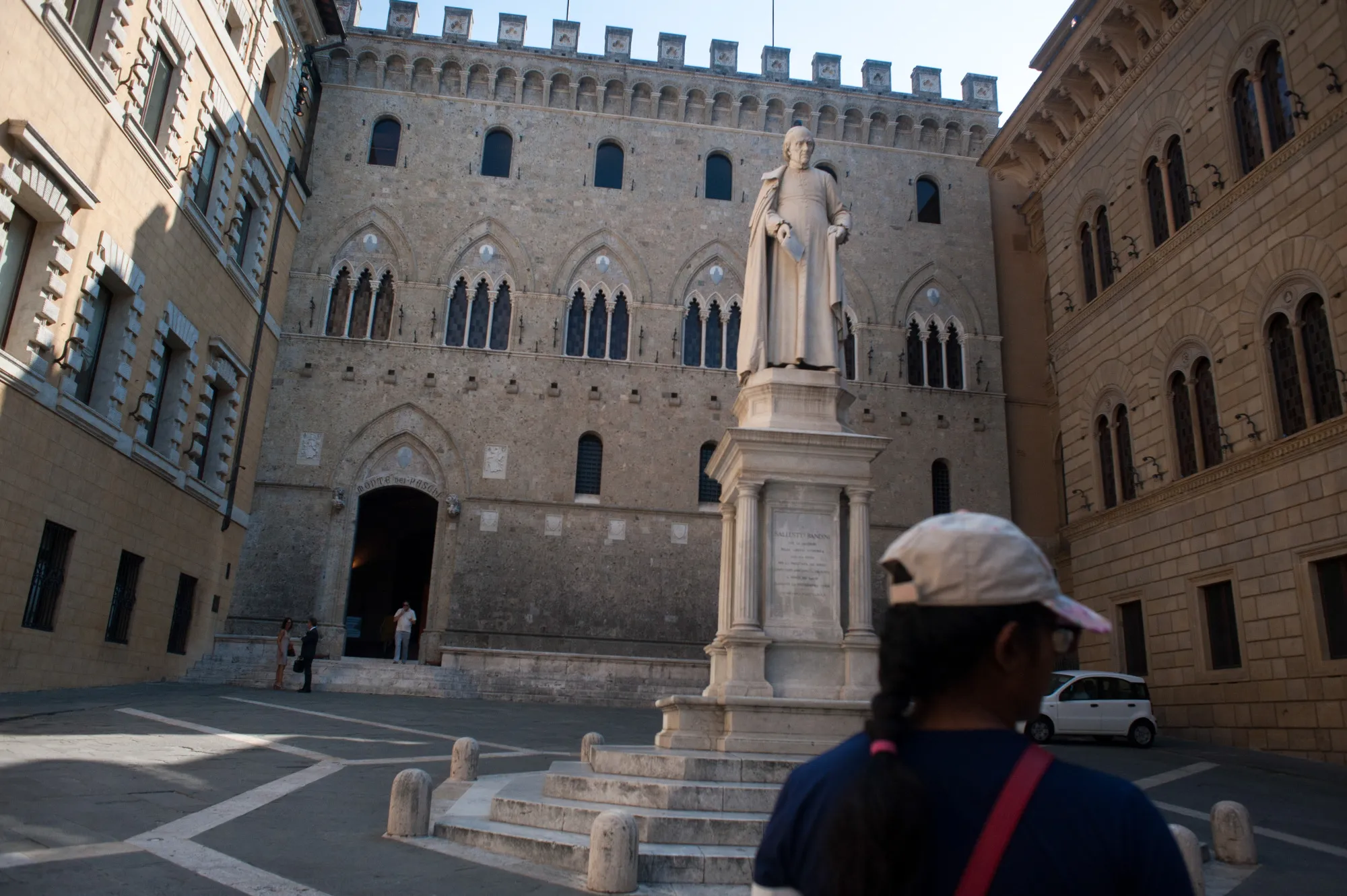 A statue of Sallustio Bandini, an economist and politician, stands in Piazza Salimbeni in front of the Banca Monte dei Paschi di Siena headquarters in Siena, Italy.