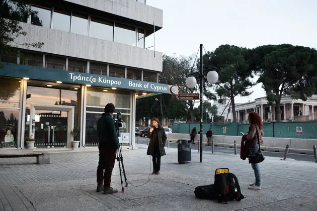 A TV reporter covering the crisis in Nicosia, Cyprus