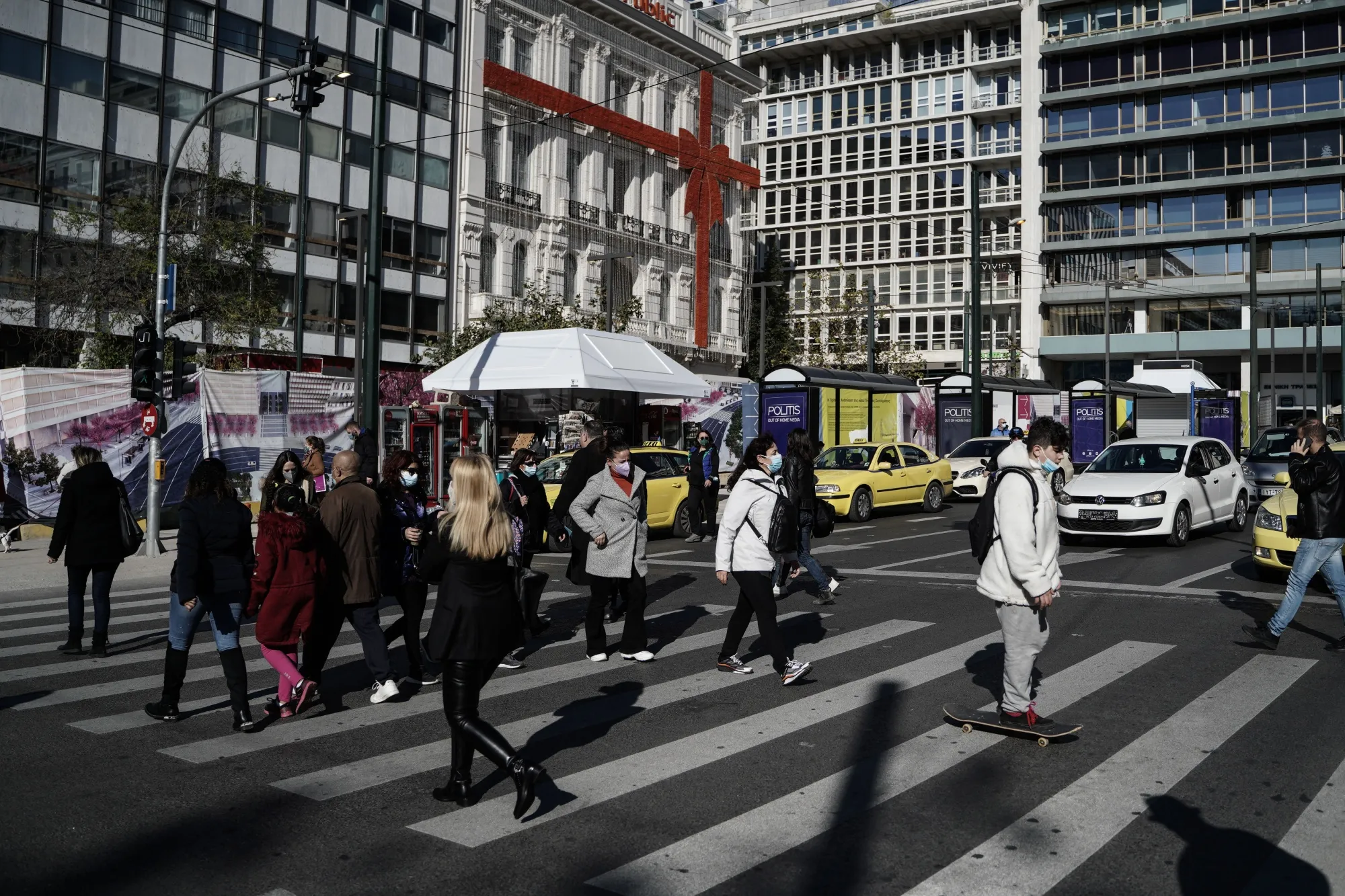 Pedestrians wearing face masks cross a street near Syntagma Square, in Athens, Greece, on&nbsp;Jan. 4.&nbsp;