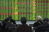 Investors look at a screen showing stock market movements at a securities company in Hangzhou in China's eastern Zhejiang province on February 3, 2020. - Chinese stocks crashed on February 3 with some major shares quickly falling by the maximum daily limit as the country's investors got their first chance in more than a week to react to the spiralling coronavirus outbreak. (Photo by STR / AFP) / China OUT (Photo by STR/AFP via Getty Images)