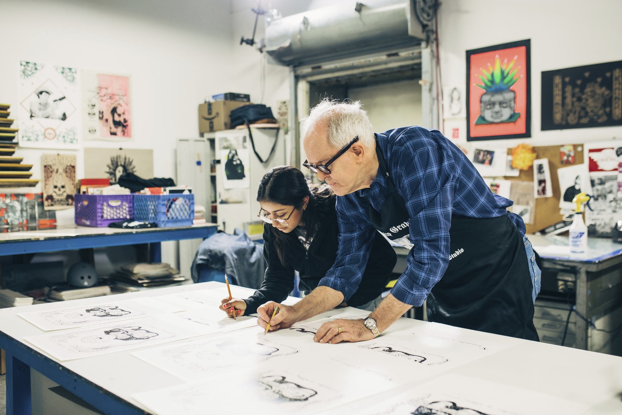 This image released by PBS shows actor John Lithgow, right, with Yoli, as they work on a screen print drawing during the filming of &quot;Art Happens Here With John Lithgow,&quot; premiering April 26. (Antonio Diaz/PBS SoCal via AP)