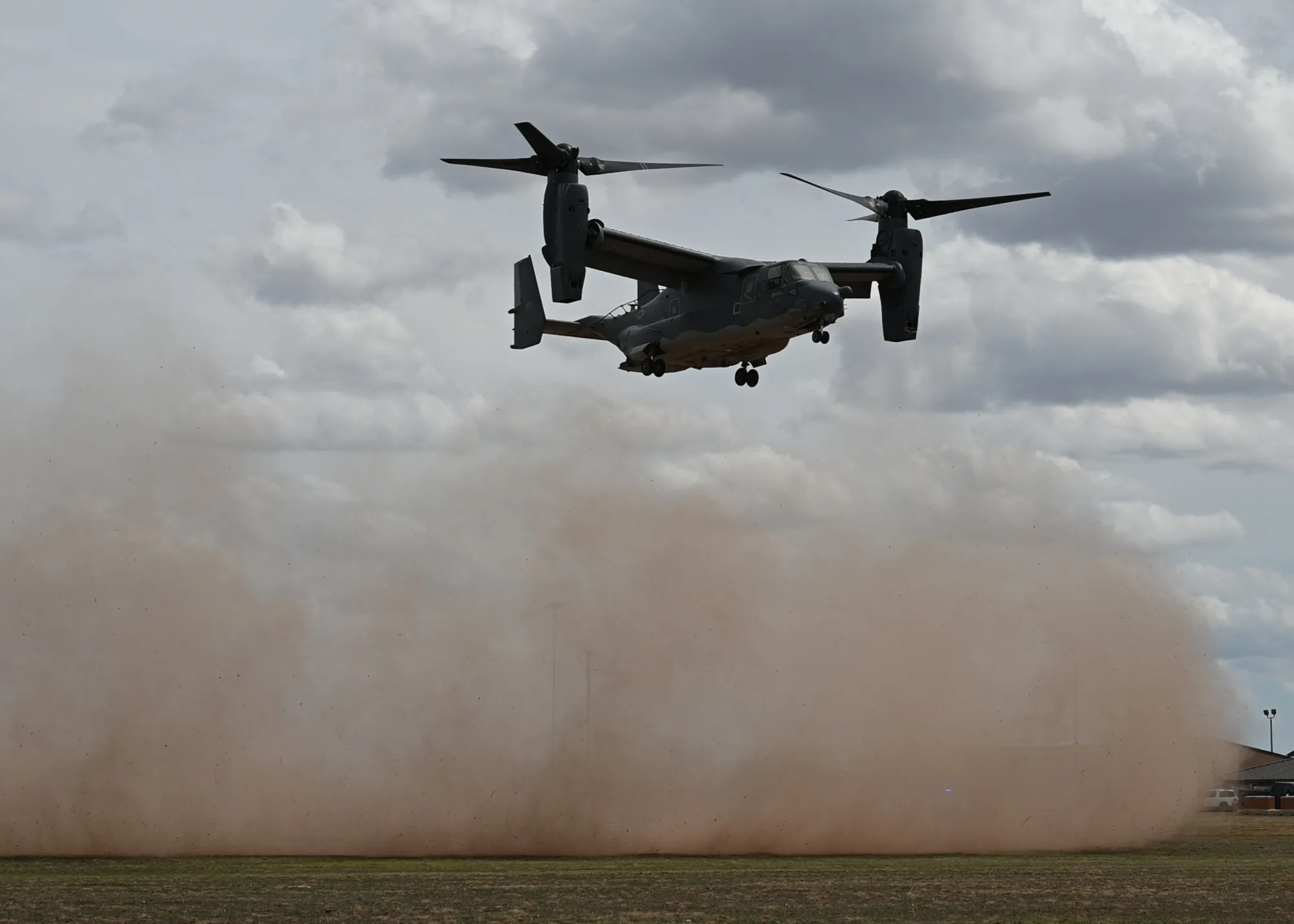 A CV-22 Osprey lands in a field at Goodfellow Air Force Base, Texas.
