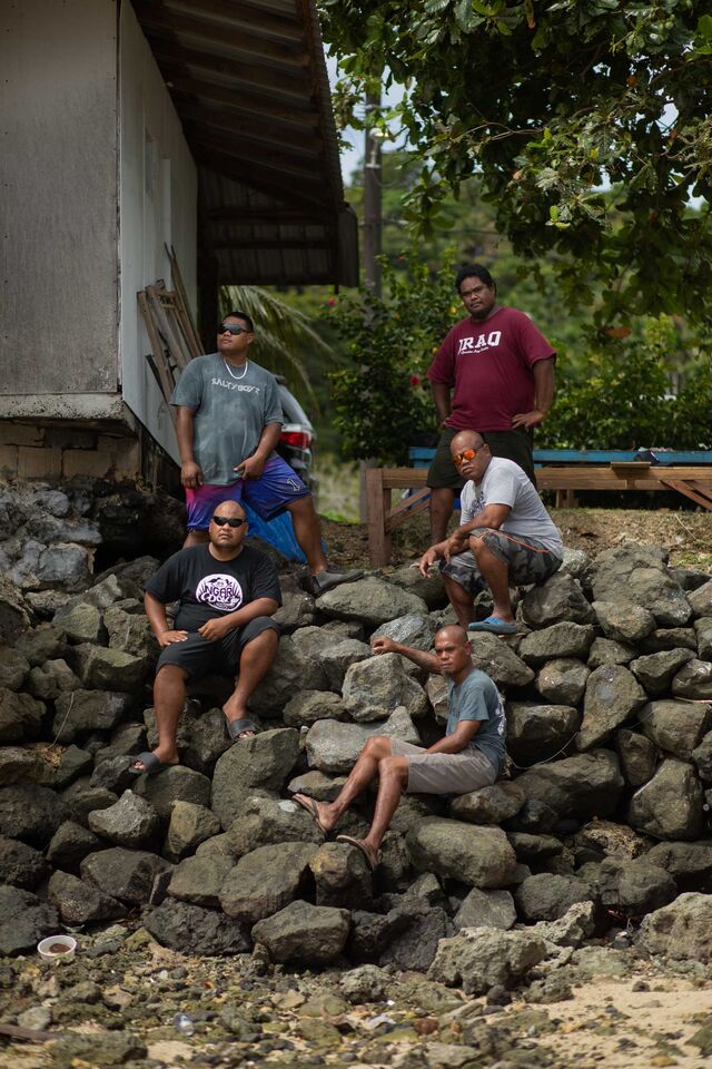 To help prevent shoreline erosion, volunteers with the men's club Ngaramecherocher build up rock walls along the beach. 
