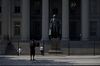 A visitor takes a photograph outside the U.S. Treasury building in Washington, D.C., U.S., on Monday, July 16, 2018. The House this week plans to consider a minibus spending bill that combines legislation funding the Treasury, Internal Revenue Service (IRS), and the Securities and Exchange Commission (SEC) with another bill keeping the Interior Department and Environmental Protection Agency (EPA) running.