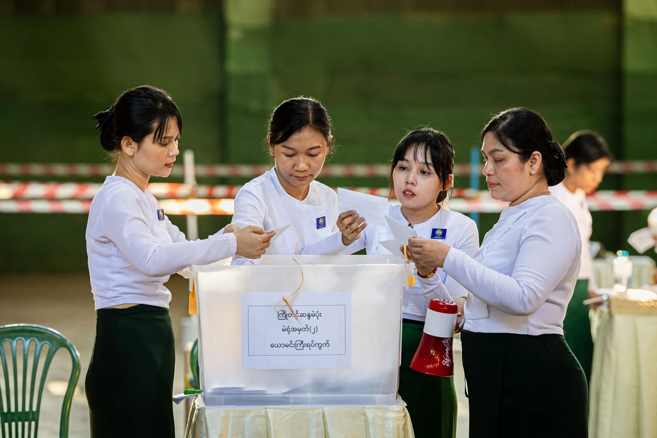 Polling station workers count ballots after the polls close in Myanmar’s election on Sunday.&nbsp;