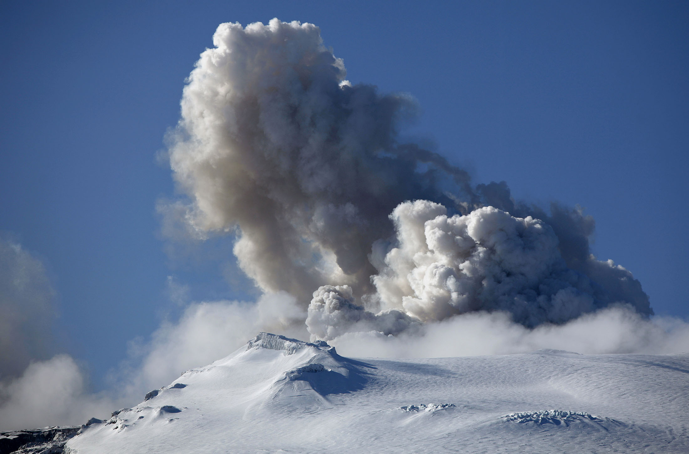 FILE- A plume of ash, dust and steam emits from a volcano erupting beneath Iceland's Eyjafjallajokull glacier, in this file photo dated Wednesday, April 21, 2010, in Eyjafjallajokull, Iceland. A surge of small earthquakes has been reported Tuesday Sept. 6, 2011, around Iceland's Katla volcano, but scientists said Tuesday there is no immediate concern that the increased seismic activity will trigger a dangerous eruption, although history has shown that when the Eyjafjallajokull volcano erupts, Katla isn't far behind.
