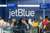 Travelers line up to check-in for JetBlue flights in Terminal 5 at John F. Kennedy International Airport.