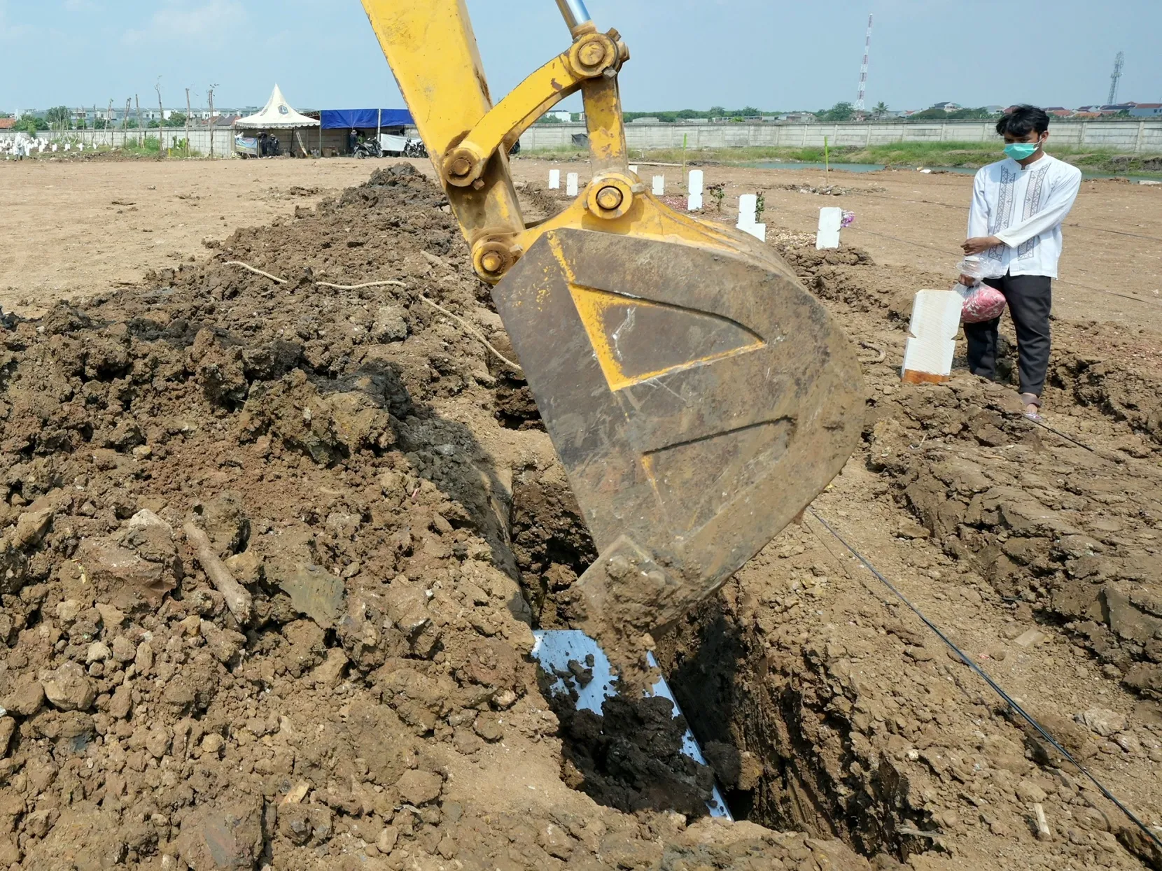 Funeral workers bury Covid-19 victims at a cemetery in Jakarta on Aug. 4.