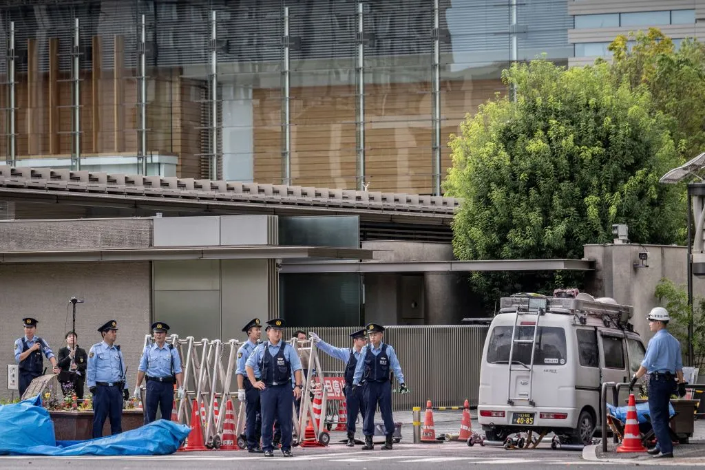 Police officers investigate a vehicle outside the prime minister's official residence, in Tokyo, on Oct.&nbsp;19.