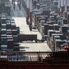 A truck transports a container at the Yangshan Deep Water Port in Shanghai, China, on Tuesday, July 10, 2018. China told companies to boost imports of goods from soybeans to seafood and automobiles from countries other than the U.S. after trade tensions between the world's two biggest economies escalated into a tariff war last week.