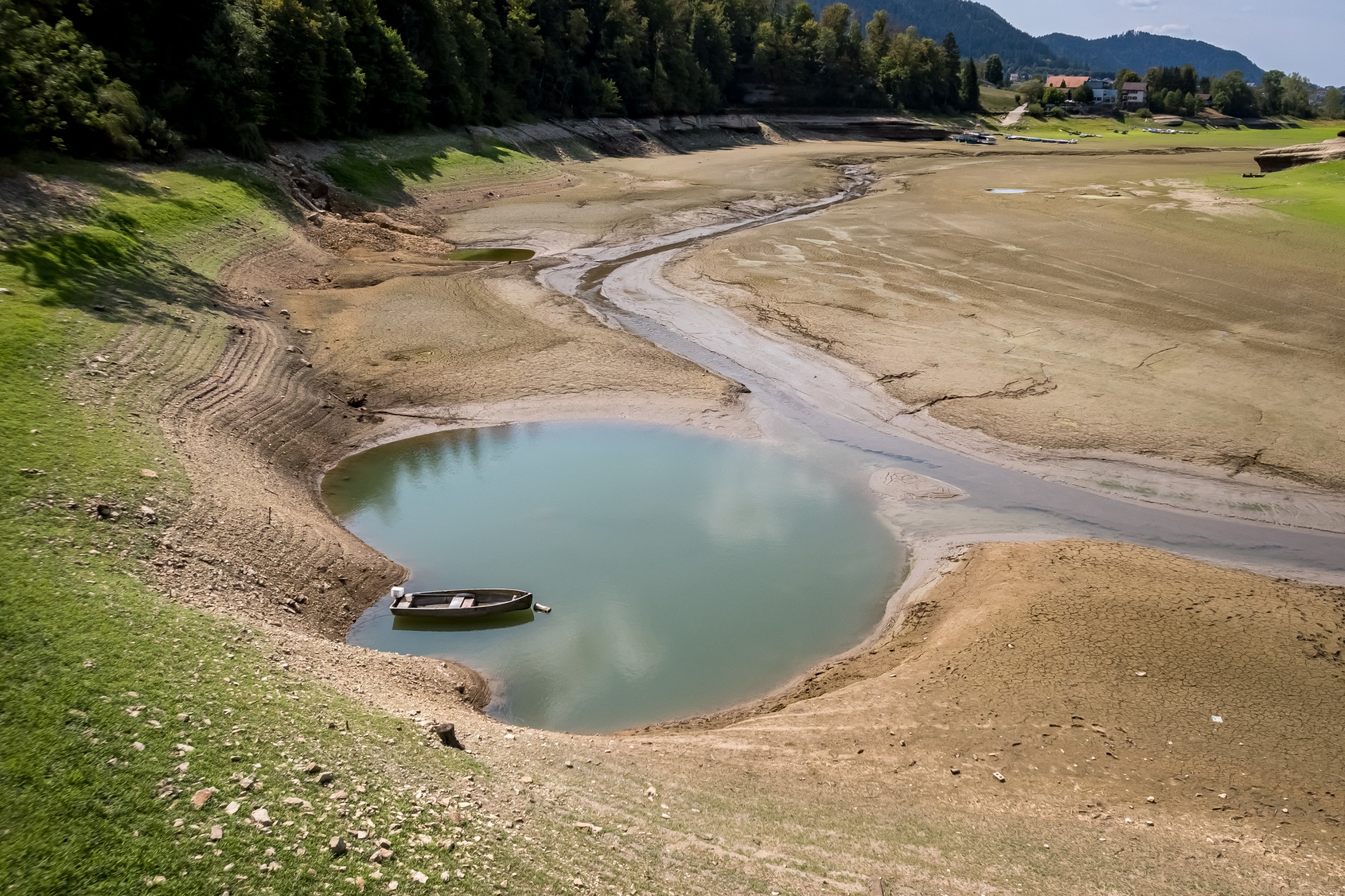 The exposed bed of Brenets Lake, part of the Doubs River, on Aug. 11. Photographer: Fabrice Coffrini/AFP/Getty Images