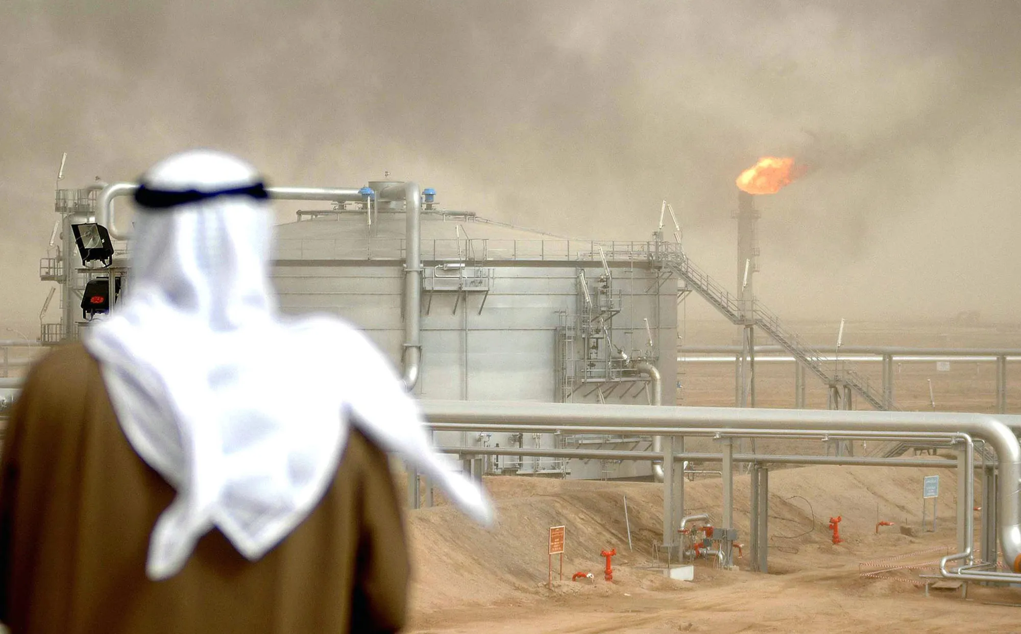 An employee of the Kuwait Oil Company&nbsp;views an oil field in Kuwait City.