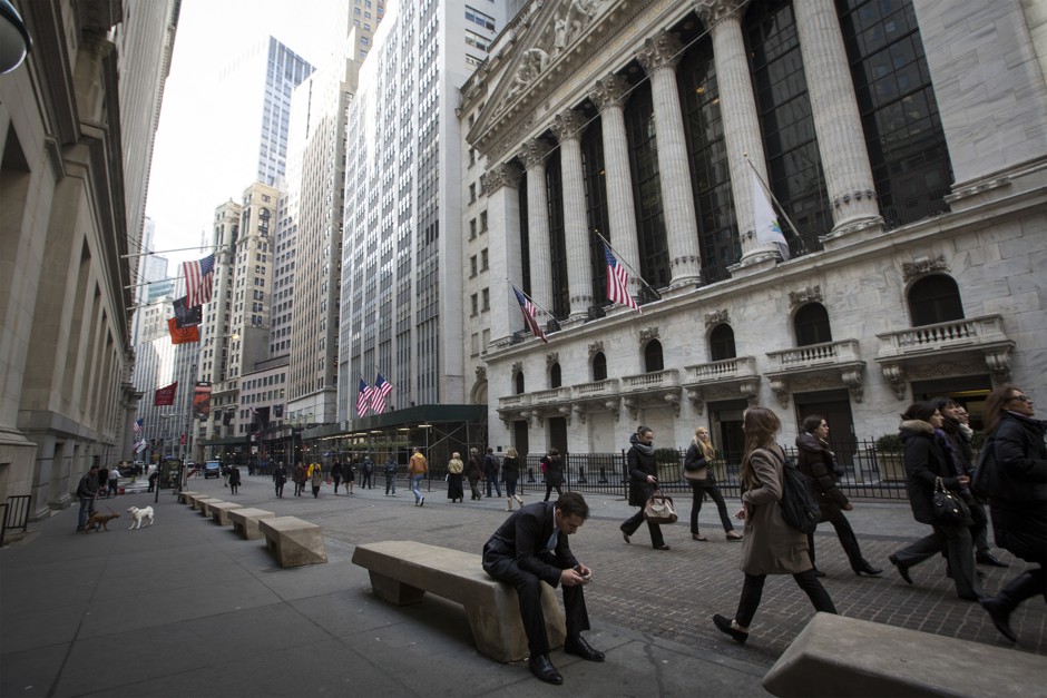 People walk by the New York Stock Exchange in New York's financial district.